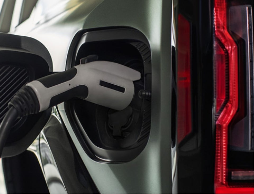 Close up of charging port with charger plugged in on a GMC Hummer EV SUV - Bruner GMC Early in Early TX